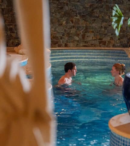 Couple relaxing and chatting while having a bath in Muckross vitality indoor pool