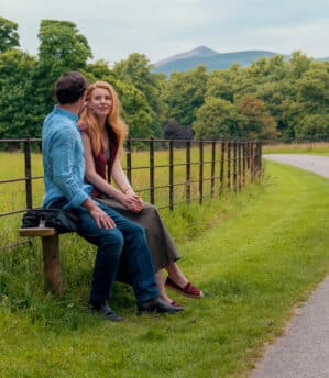 Couple enjoying a moment sitting on a bench inside Killarney National Park near Muckross Park Hotel