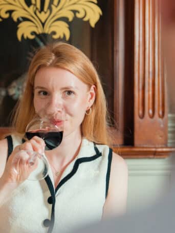 Guest enjoying a glass of red wine at Yew Tree Restaurant in Muckross Park Hotel