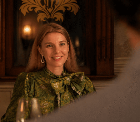 Guest enjoys elegant dining in ornate hotel restaurant, warm lighting, vintage decor, attentive service.