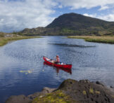 Canoeing on The Long Range, Killarney Lakes, Killarney National Park, County Kerry, Ireland.