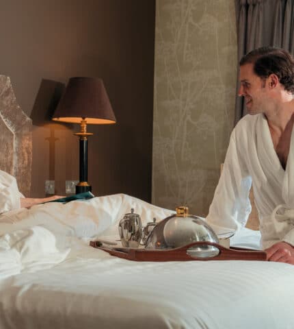 Couple enjoying an in-room breakfast during a spa break at Muckross Park Hotel