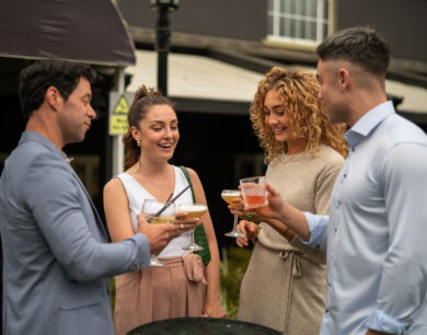 Guests smiling and enjoying cocktails outside Colgans at Muckross Park Hotel