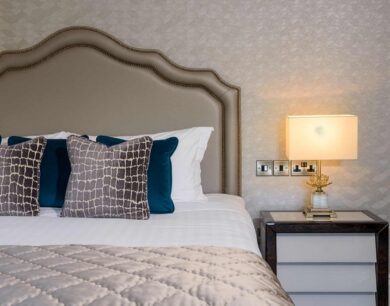 Junior Suite bedroom with statement headboard and soft cushions at Muckross Park Hotel