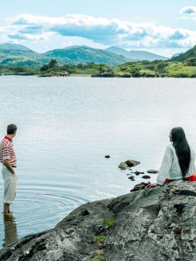 Guests enjoying scenic mountain lake view, perfect for relaxation and nature escapes, with serene waters and lush greenery.