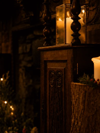 Cosy hotel lounge with warm candlelight, rustic wooden décor, festive wreaths, and ambient lighting for a welcoming stay.