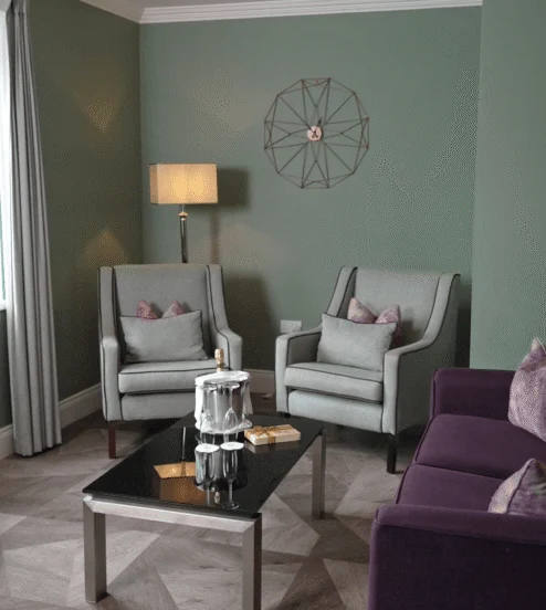 Spacious living room with sofa and armchairs in The Reserve at Muckross Park, Killarney.